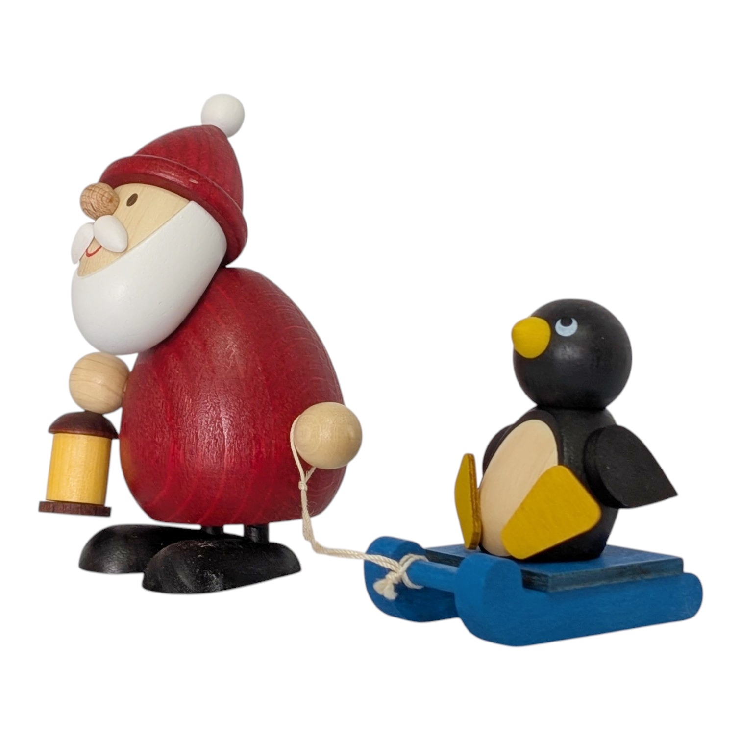 Weihnachtsmann mit Schlitten und Pinguin