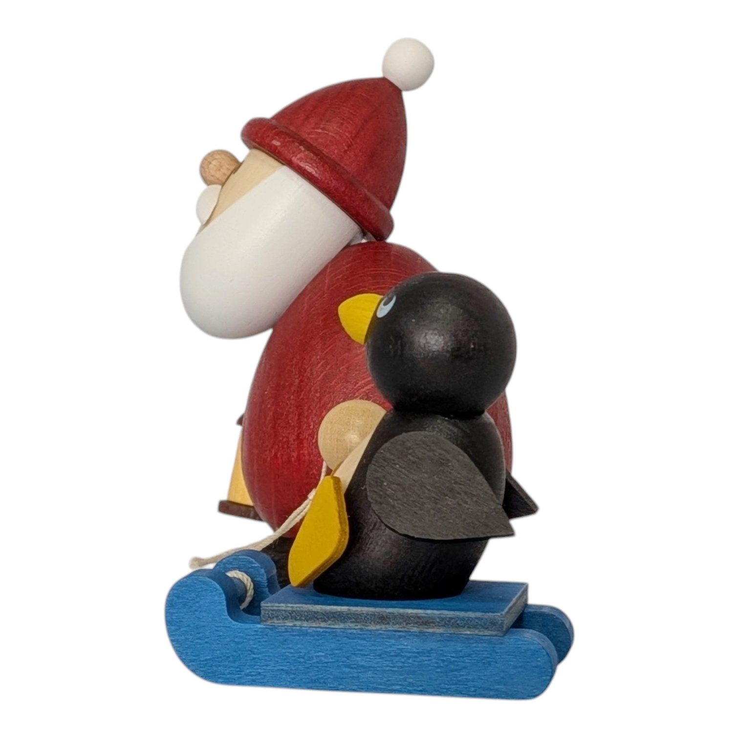 Weihnachtsmann mit Schlitten und Pinguin