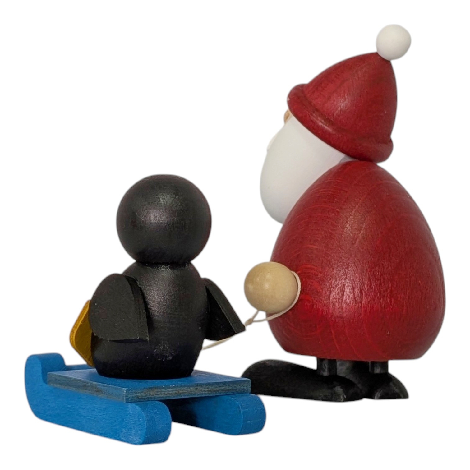 Weihnachtsmann mit Schlitten und Pinguin