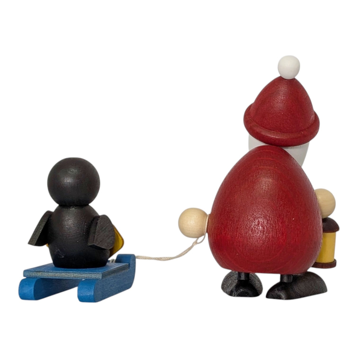Weihnachtsmann mit Schlitten und Pinguin