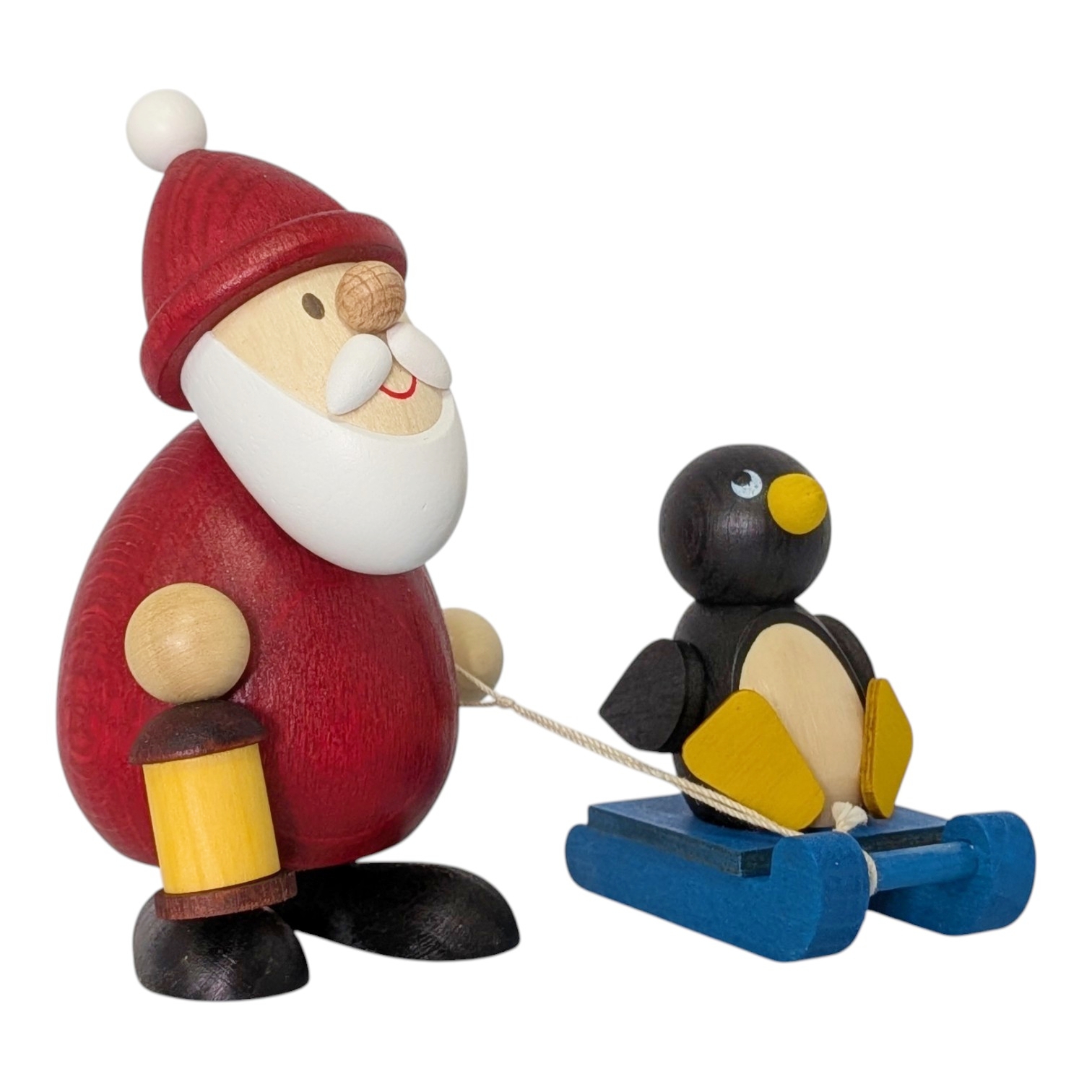 Weihnachtsmann mit Schlitten und Pinguin